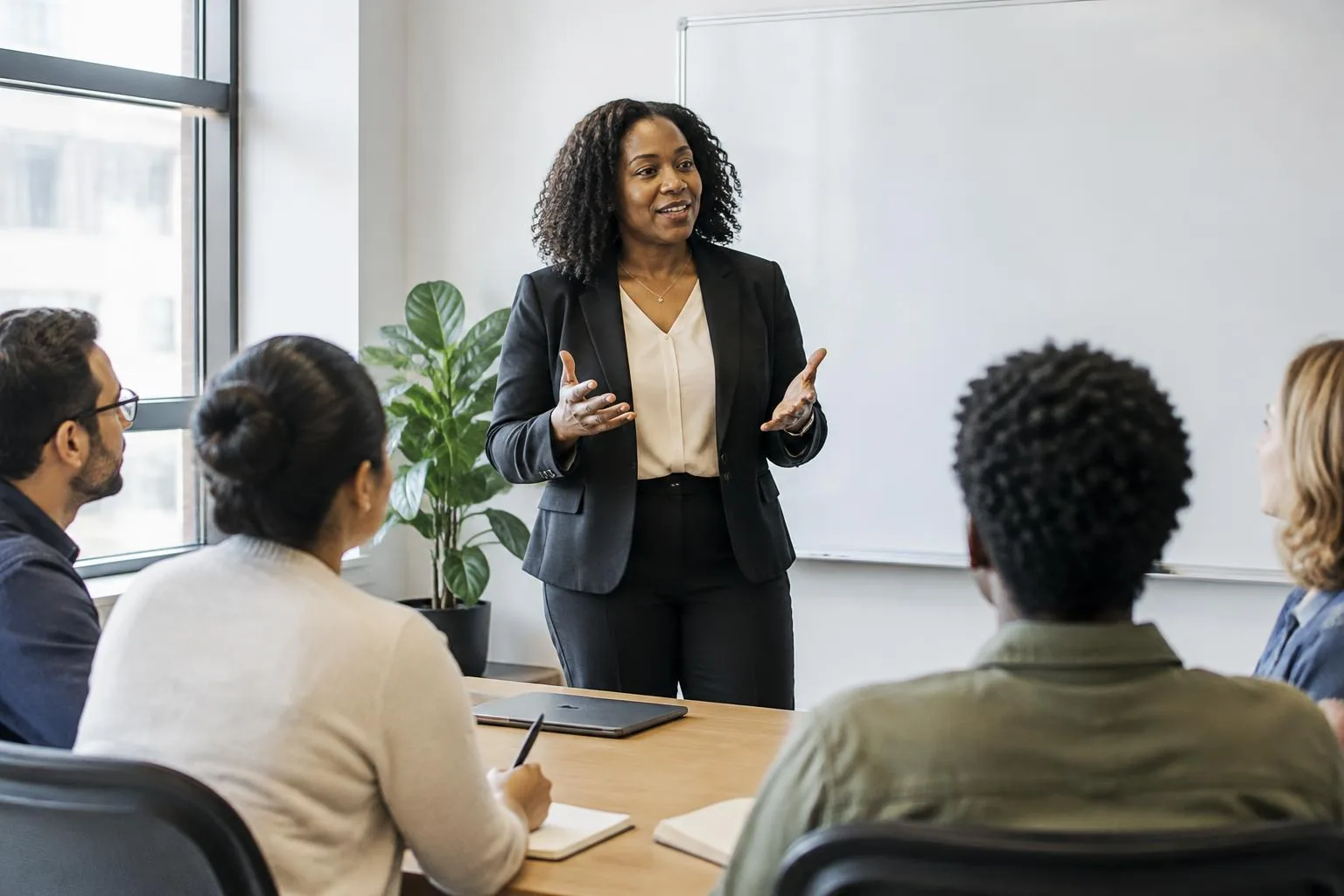 HR leader presenting to colleagues in a meeting room