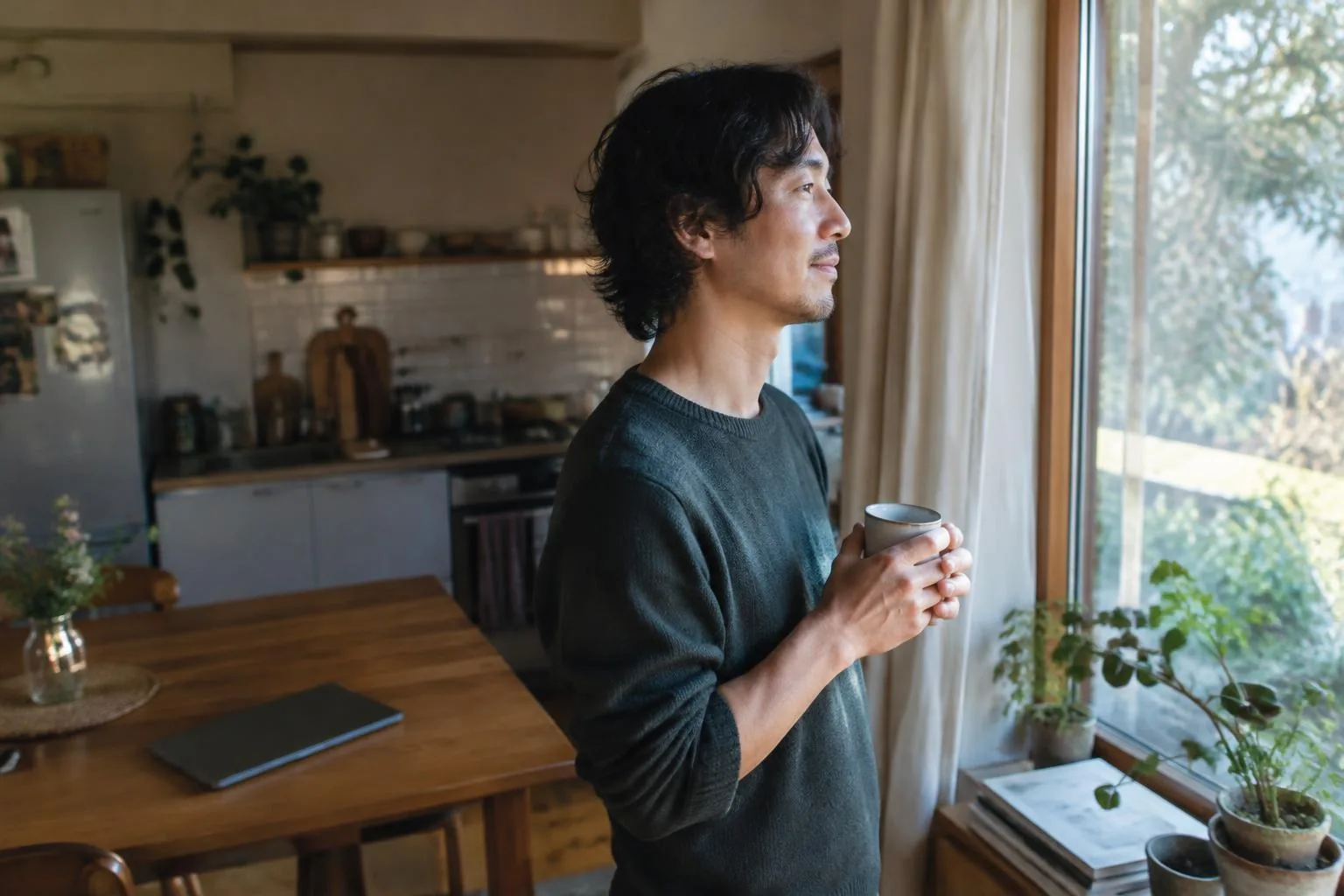 Remote worker taking a screen-free tea break at a window